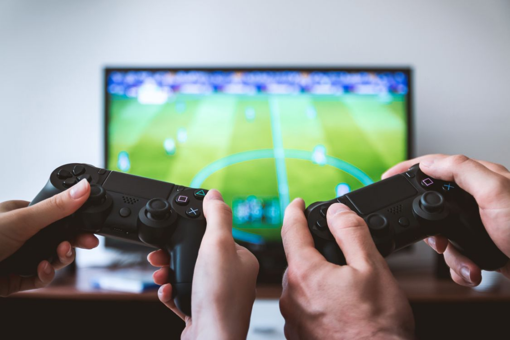 A gaming setup with a controller and game library, representing the comparison of DLC, expansion packs, and season passes.